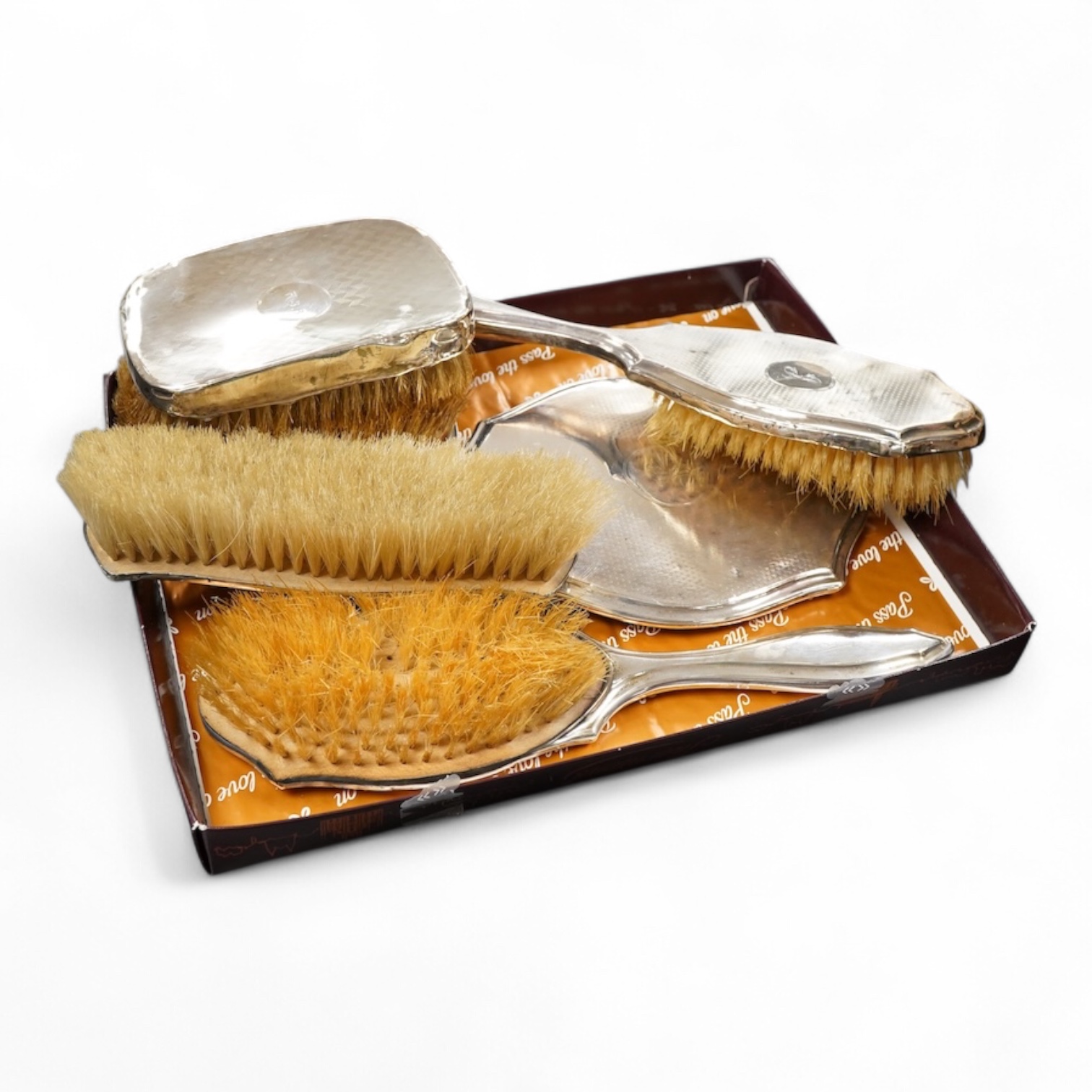 A George V silver engine turned four piece dressing table set and a pair of clothes brushes hand mirror length 19.3cm.